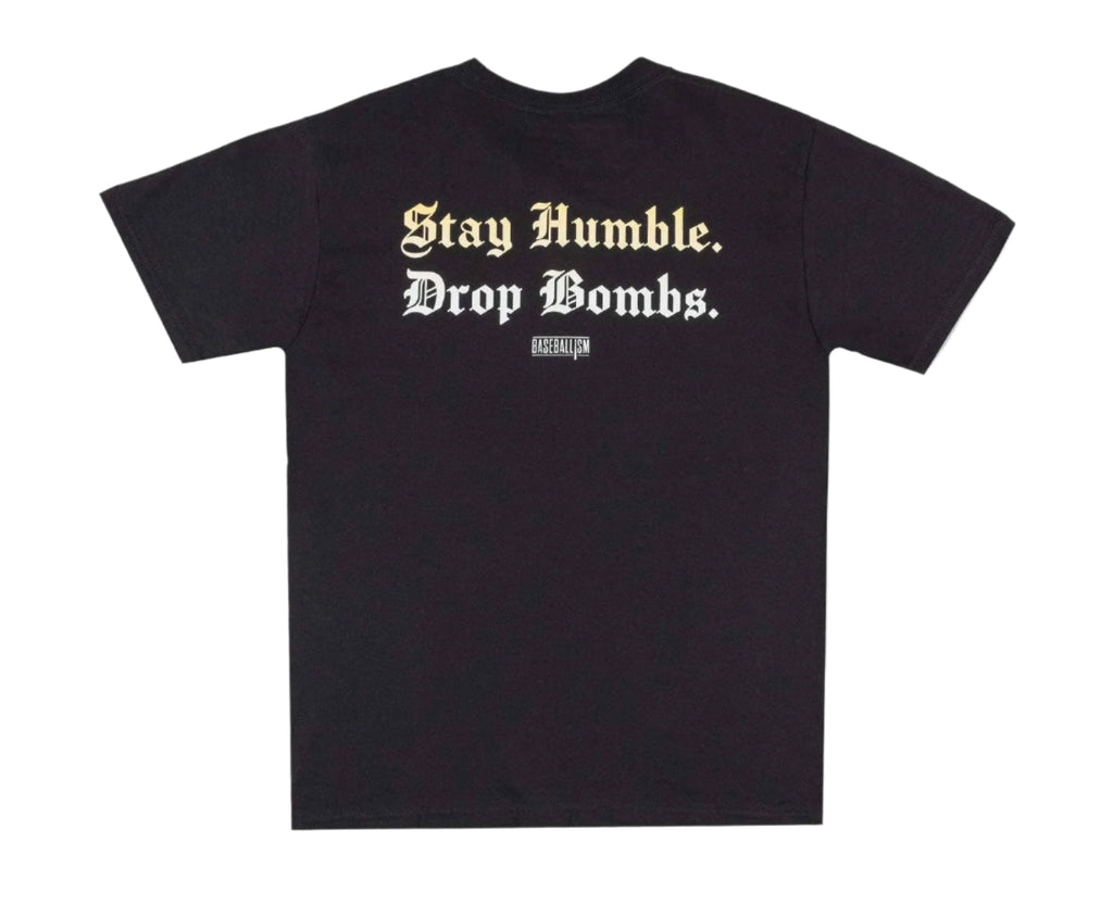 Black t-shirt with white text 'Stay Humble. Drop Bombs.' on a light gray background