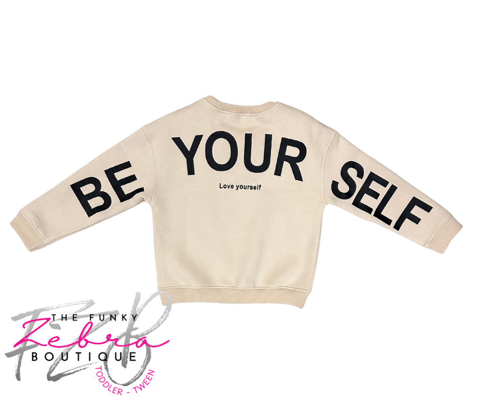 Beige sweatshirt with 'BE YOURSELF' text on a white background, featuring The Funky Zebra Boutique logo.