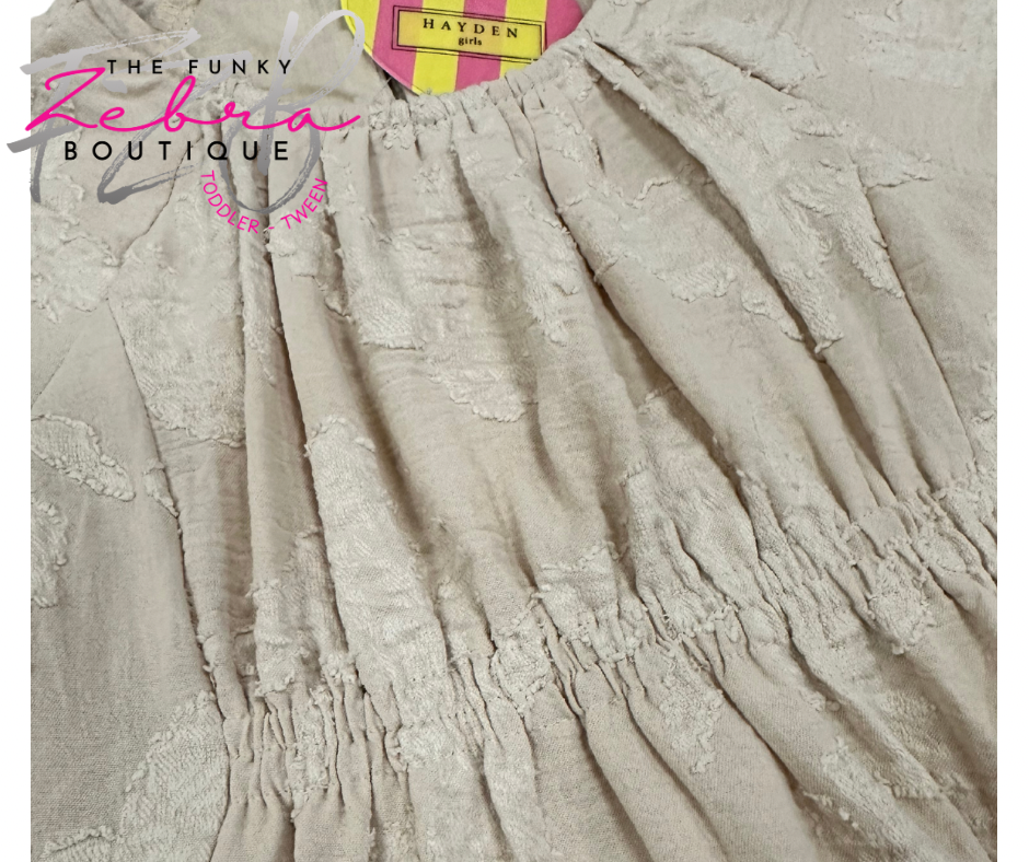 Beige textured dress with 'The Funky Zebra Boutique' label on a white background