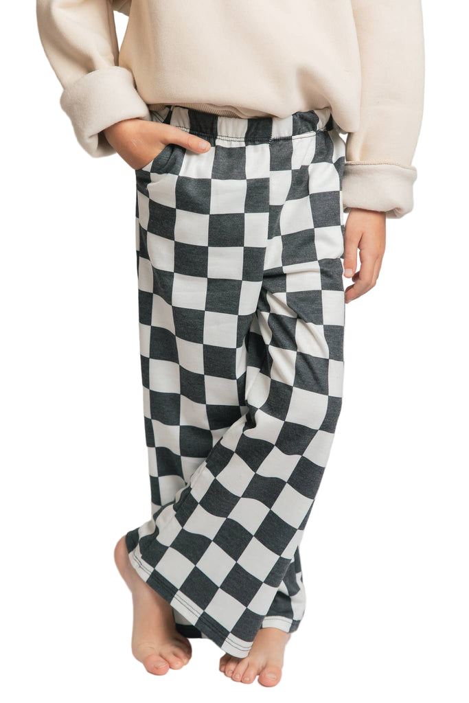 Person wearing checkered pants on a plain background