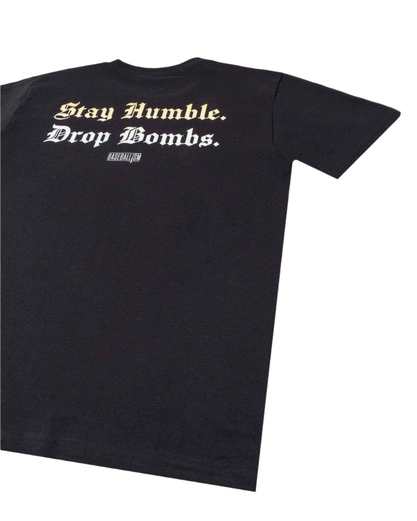 Black t-shirt with 'Stay Humble, Drop Bombs' text on a light gray background